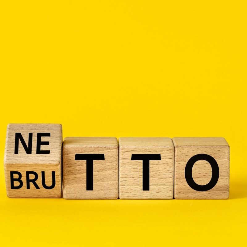 netto and brutto. net and gross symbol. words on wooden blocks change net to gross. financial concept, beautiful yellow background, copy space